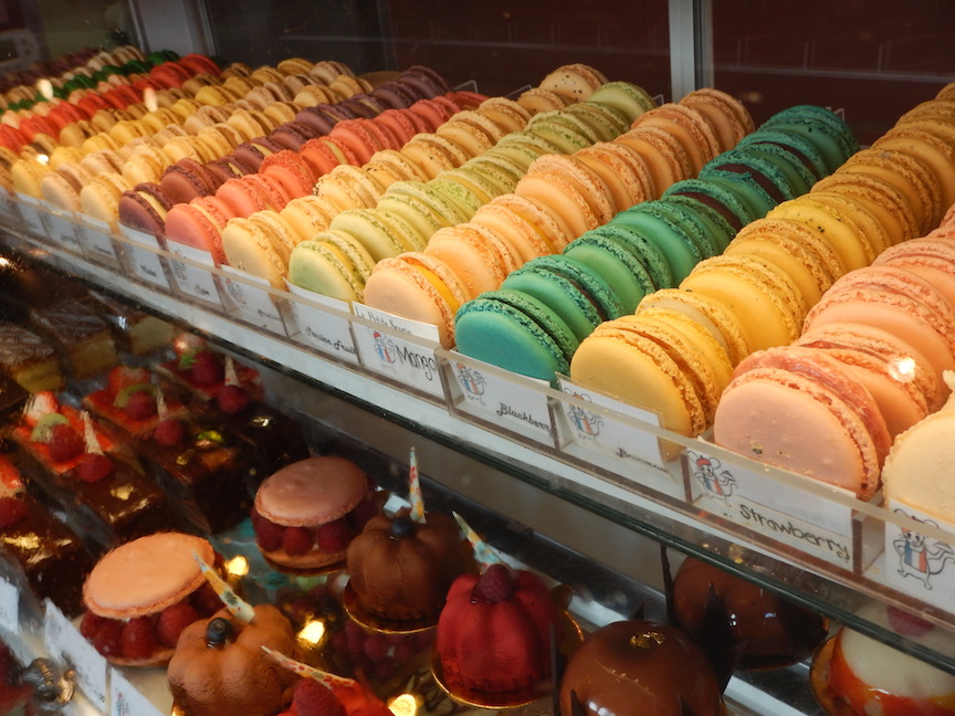 A rainbow of macaroons and fruit tarts brighten the pastry case. (Photo by Tom Adkinson)